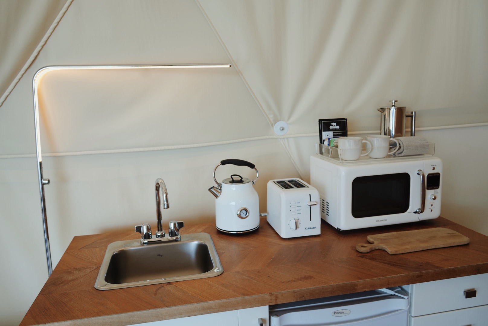 Kitchenette counter with kettle, toaster, and microwave
