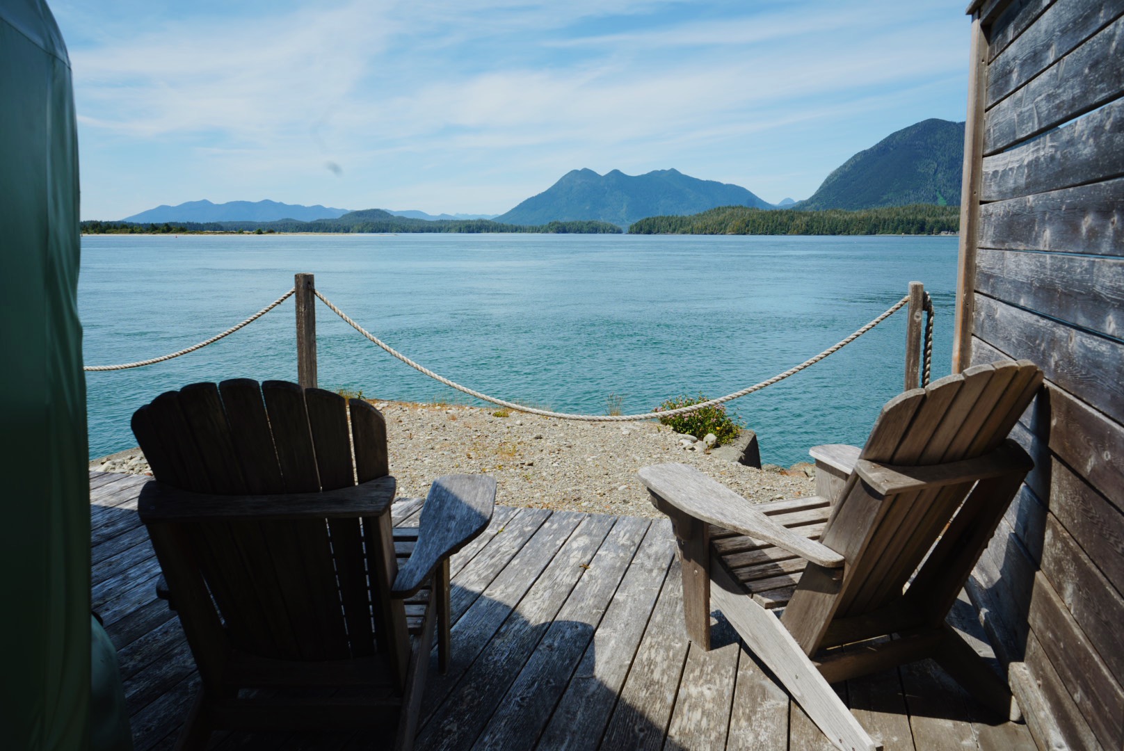 Adirondack chairs on a deck overlooking the water