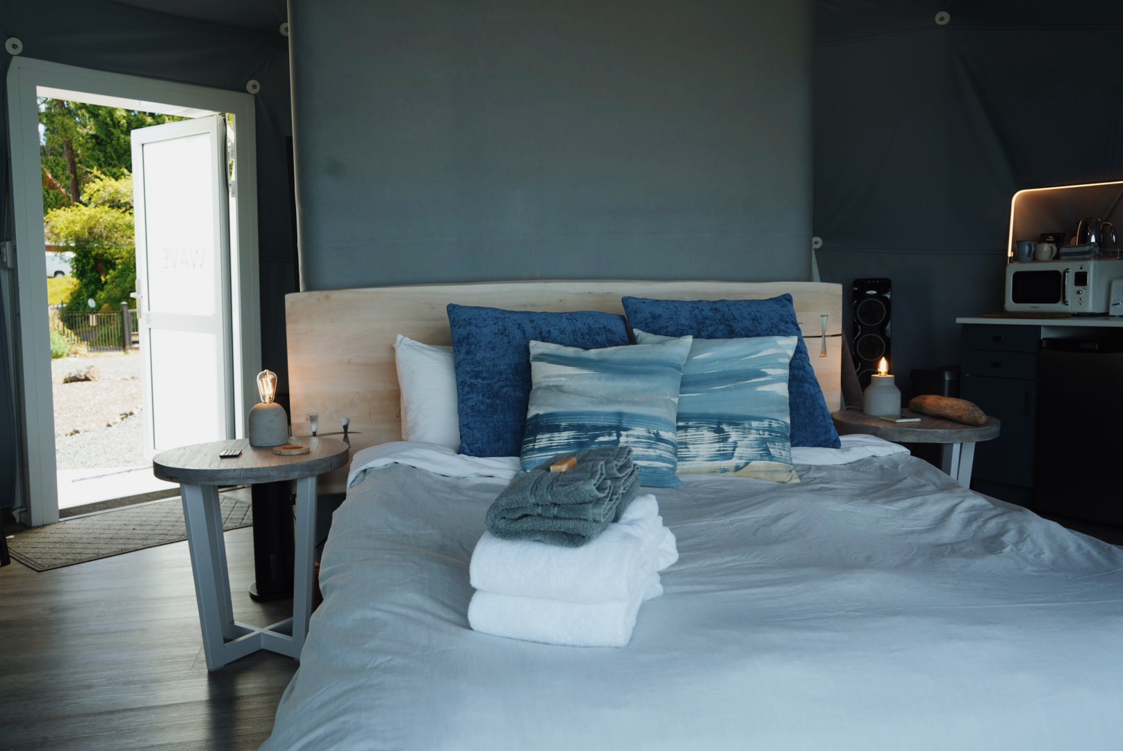 Wave Pod interior with a queen bed and kitchenette